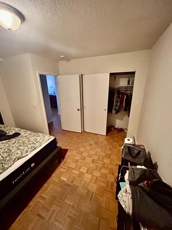 bedroom with a closet and a textured ceiling