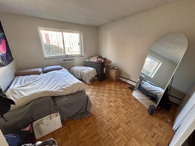 bedroom featuring baseboard heating and an AC wall unit