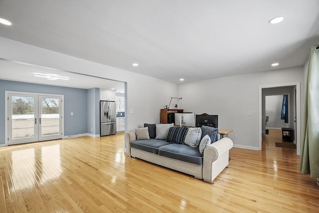 living area with light wood-type flooring, french doors, baseboards, and recessed lighting