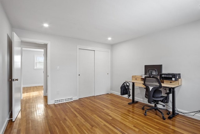 office area featuring hardwood / wood-style floors, recessed lighting, visible vents, and baseboards