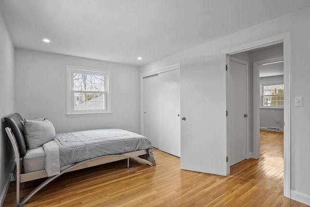 bedroom featuring light wood-style floors, a closet, and recessed lighting