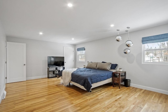 bedroom with light wood finished floors, baseboards, and recessed lighting