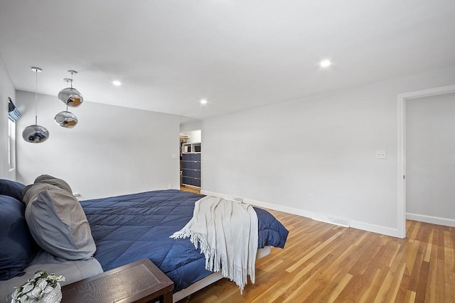 bedroom featuring recessed lighting, baseboards, and light wood finished floors