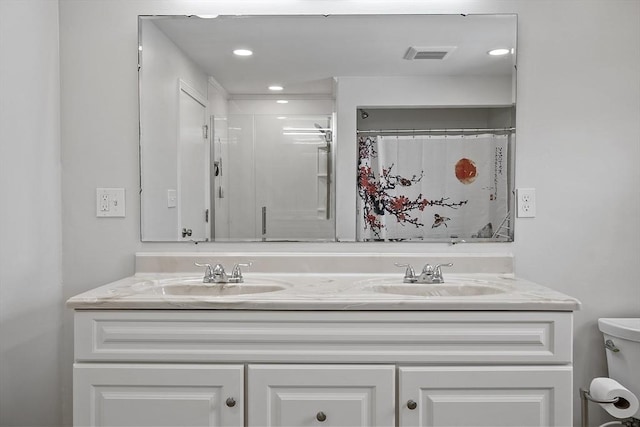 full bath featuring double vanity, a sink, visible vents, and a shower with curtain