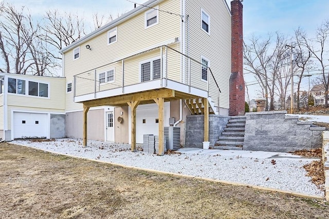 view of front of property featuring a garage and stairs