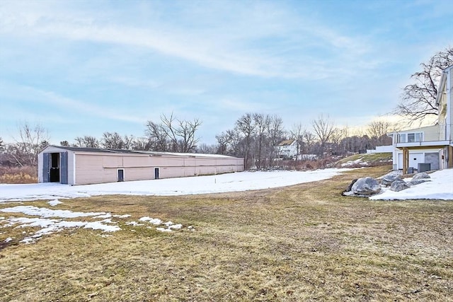 yard layered in snow with an outdoor structure