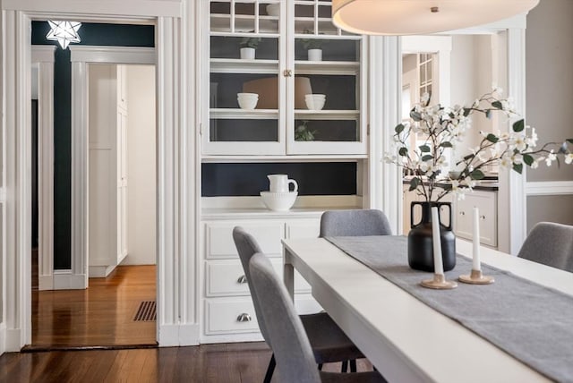 dining space featuring dark wood finished floors and visible vents