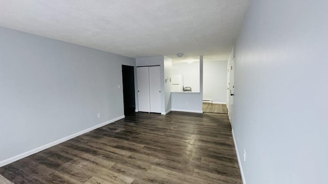 137 Winthrop St Unit 14A, Framingham, MA 01702 - empty room with dark wood finished floors, a baseboard heating unit, and baseboards