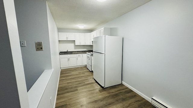 137 Winthrop St Unit 14A, Framingham, MA 01702 - kitchen featuring white appliances, a baseboard radiator, dark countertops, dark wood finished floors, and a sink