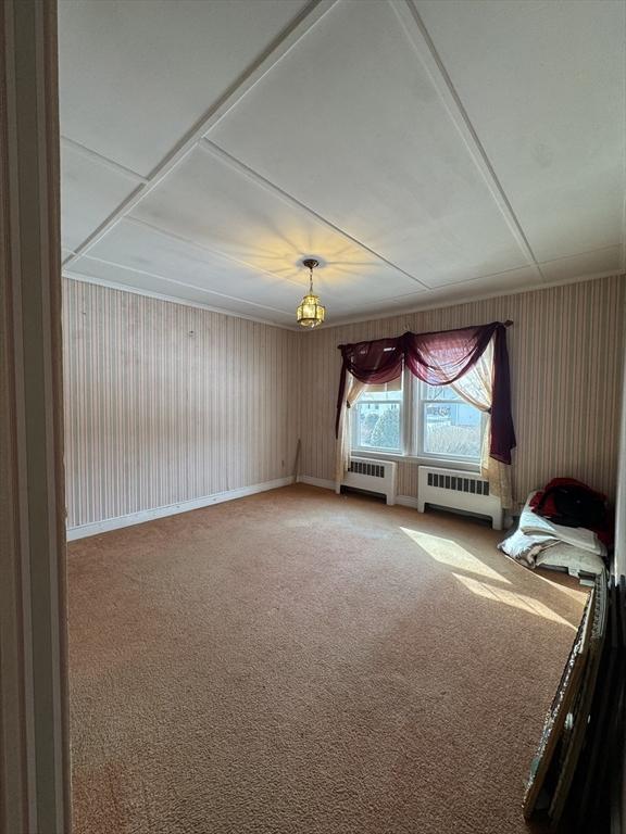 interior space featuring baseboards and radiator