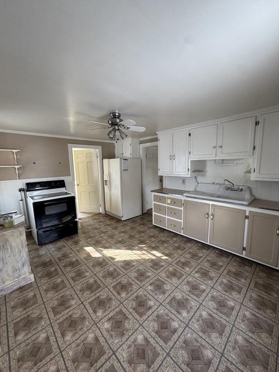 kitchen with white refrigerator with ice dispenser, black range with electric stovetop, light countertops, white cabinetry, and a sink