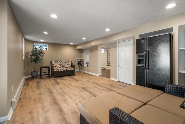 living area featuring recessed lighting, baseboards, light wood finished floors, and baseboard heating