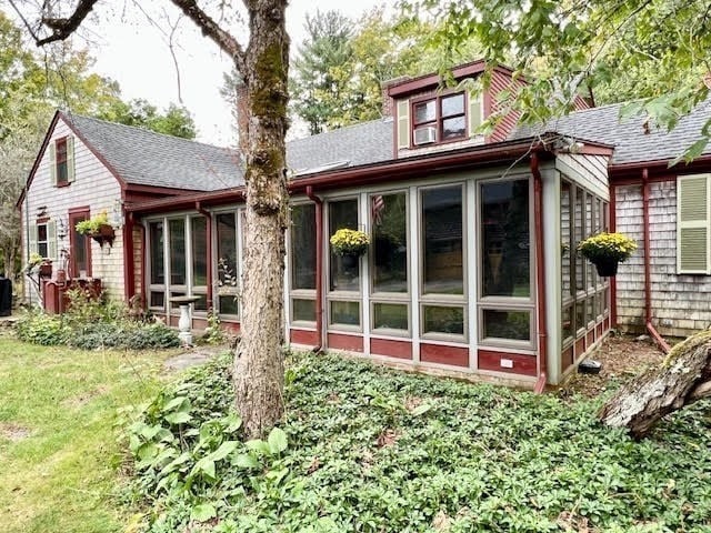 back of house with a sunroom