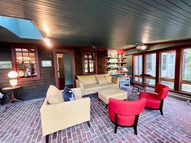 living room with a skylight and ceiling fan