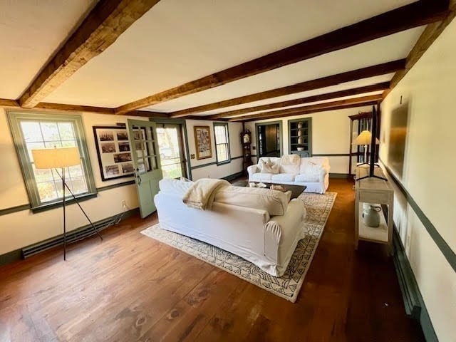 bedroom featuring beam ceiling and dark wood-type flooring