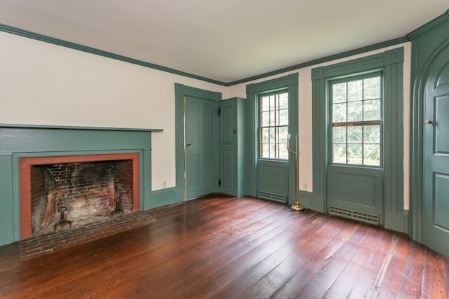 interior space with ornamental molding, a fireplace, and dark hardwood / wood-style flooring