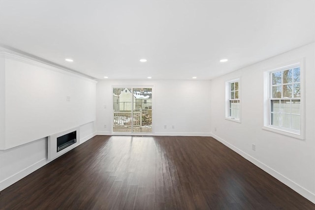 unfurnished living room with a fireplace and dark hardwood / wood-style floors