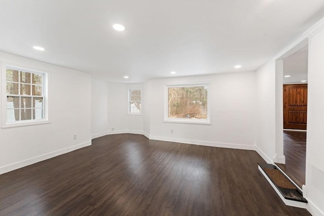 spare room with dark hardwood / wood-style floors