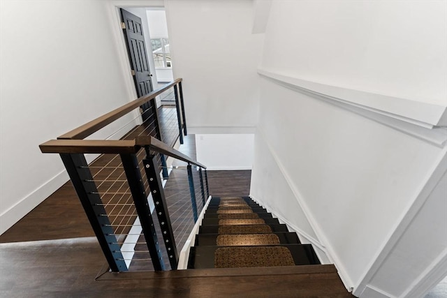 stairway featuring hardwood / wood-style floors