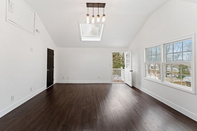 unfurnished living room featuring lofted ceiling with skylight and dark hardwood / wood-style floors