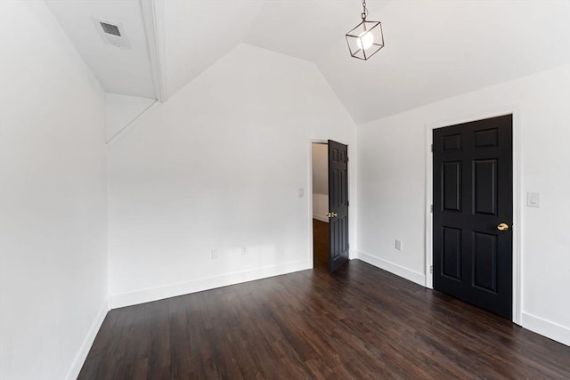 empty room with vaulted ceiling and dark hardwood / wood-style flooring