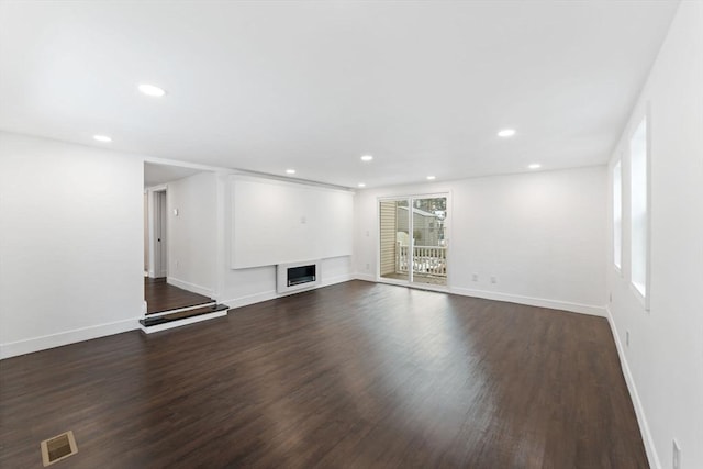 unfurnished living room featuring dark hardwood / wood-style floors and a fireplace