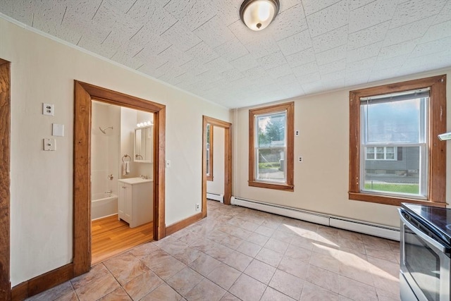 84 Tremont St, Taunton, MA 02780 - unfurnished room featuring a baseboard heating unit, plenty of natural light, baseboards, and light tile patterned floors