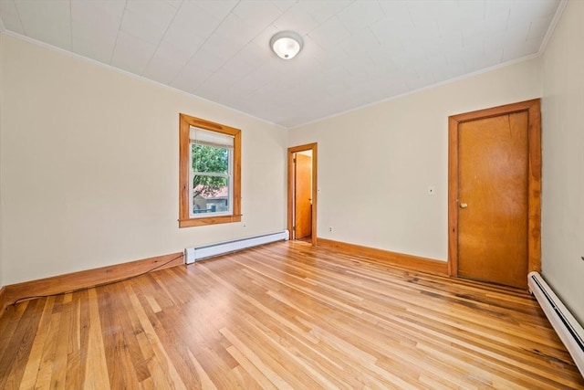 84 Tremont St, Taunton, MA 02780 - spare room featuring crown molding, a baseboard radiator, a baseboard heating unit, light wood-style floors, and baseboards