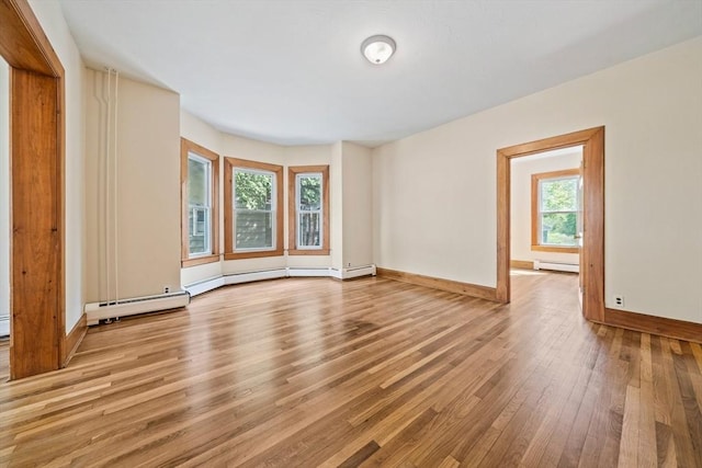 84 Tremont St, Taunton, MA 02780 - unfurnished living room with baseboard heating, wood finished floors, healthy amount of natural light, and baseboards