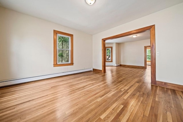 84 Tremont St, Taunton, MA 02780 - unfurnished room with a baseboard heating unit, plenty of natural light, and light wood-type flooring