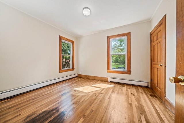 84 Tremont St, Taunton, MA 02780 - unfurnished room with a baseboard heating unit, plenty of natural light, light wood-style floors, and ornamental molding