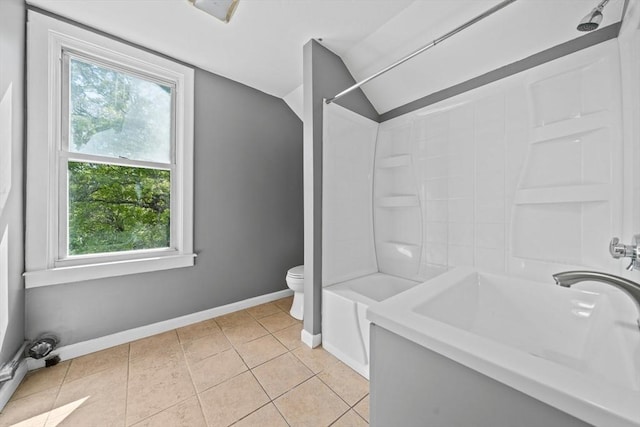 84 Tremont St, Taunton, MA 02780 - bathroom with plenty of natural light, vaulted ceiling, baseboards, toilet, and tile patterned flooring
