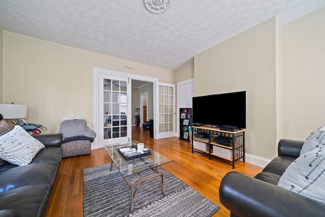 84 Tremont St, Taunton, MA 02780 - living room featuring a textured ceiling, french doors, wood finished floors, and baseboards