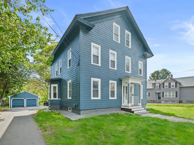 84 Tremont St, Taunton, MA 02780 - view of front of property featuring a garage, an outbuilding, and a front lawn