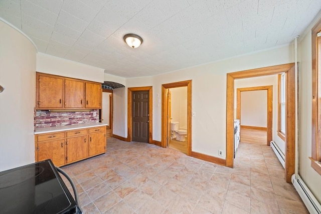 84 Tremont St, Taunton, MA 02780 - kitchen featuring baseboard heating, black range with electric stovetop, light countertops, brown cabinetry, and crown molding