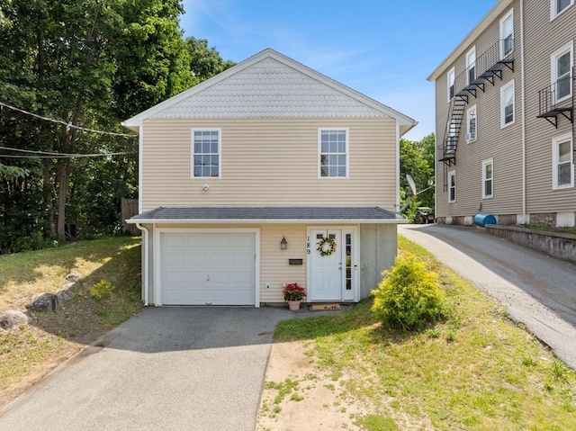 189 Progresso Ave, Woonsocket, RI 02895 - view of front facade with a garage and asphalt driveway
