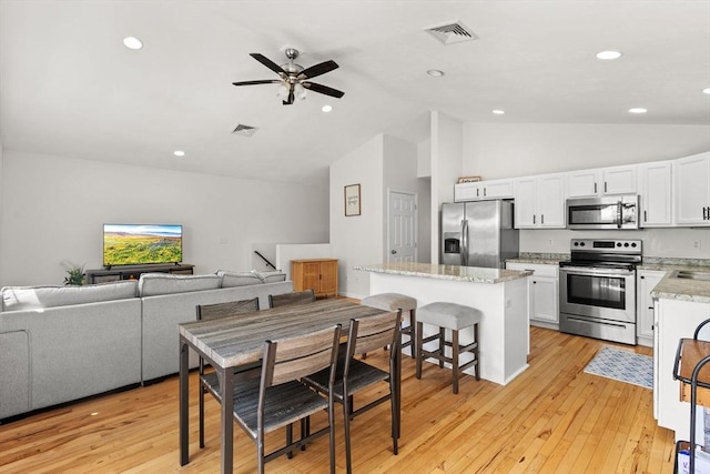 189 Progresso Ave, Woonsocket, RI 02895 - dining space featuring ceiling fan, light wood-type flooring, high vaulted ceiling, and recessed lighting