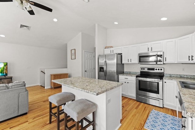 189 Progresso Ave, Woonsocket, RI 02895 - kitchen featuring appliances with stainless steel finishes, a kitchen bar, open floor plan, a center island, and ceiling fan