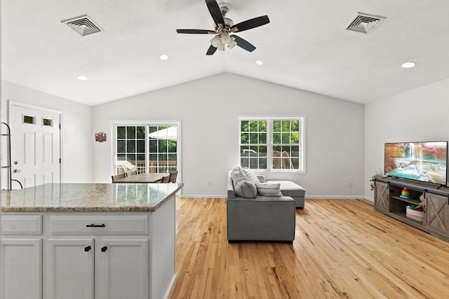 189 Progresso Ave, Woonsocket, RI 02895 - kitchen with open floor plan, light wood finished floors, a ceiling fan, lofted ceiling, and white cabinets