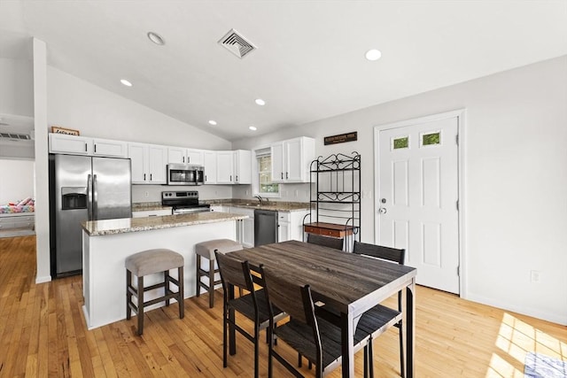189 Progresso Ave, Woonsocket, RI 02895 - dining space with vaulted ceiling, light wood-type flooring, and recessed lighting