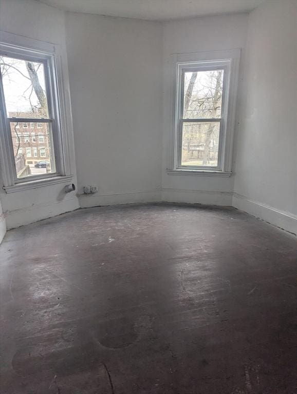 21 Mclellan St, Boston, MA 02121 - empty room with healthy amount of natural light and concrete floors