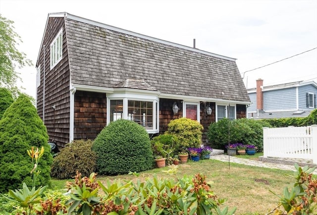 bungalow-style home with a front lawn