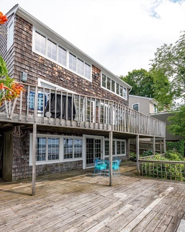 back of house featuring a wooden deck