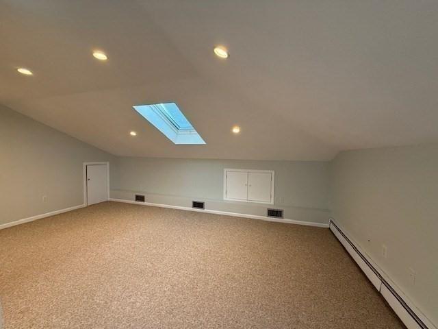 bonus room featuring carpet floors, baseboards, visible vents, and baseboard heating