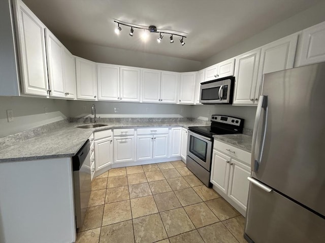 kitchen featuring stainless steel appliances, a sink, light countertops, and white cabinets