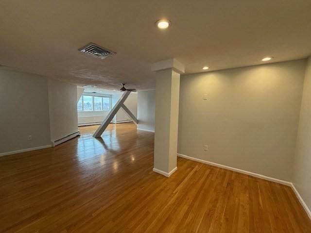 below grade area featuring recessed lighting, visible vents, ceiling fan, wood finished floors, and baseboards