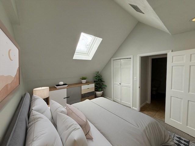 bedroom featuring lofted ceiling with skylight, a closet, and visible vents