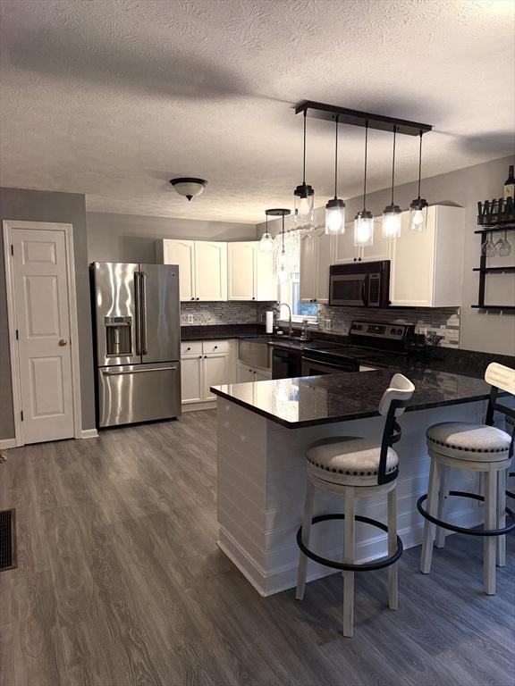 104 Orton St, Worcester, MA 01604 - kitchen featuring black microwave, stainless steel fridge with ice dispenser, range with electric cooktop, a peninsula, and dark wood finished floors