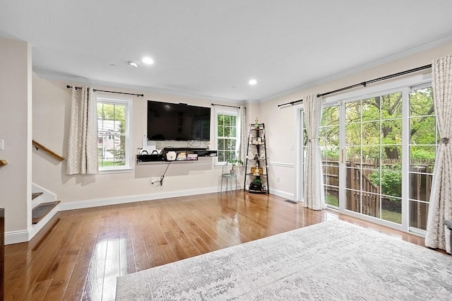 unfurnished living room with ornamental molding, baseboards, wood-type flooring, stairway, and recessed lighting