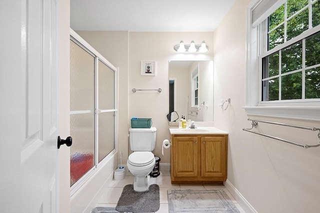 bathroom with healthy amount of natural light, vanity, baseboards, and toilet